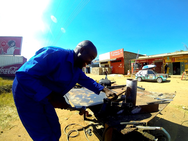Lizwe the legend manufacturing a new rack on the side of the road